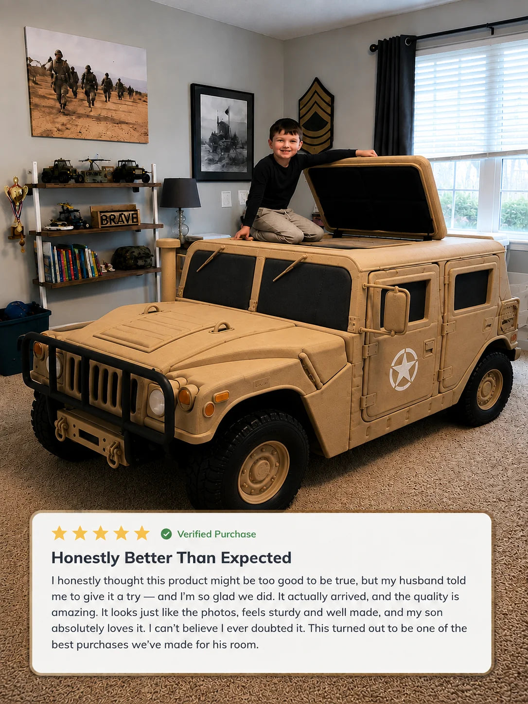 A child sits on top of a large tan military-style toy vehicle in a home office or playroom. The vehicle has black windows, a front grille, wheels, and a white star emblem on the side.